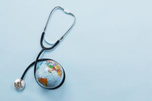 stethoscope-hugging-earth-blue-background